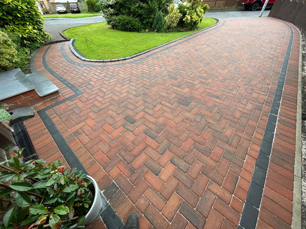 Red brindle herringbone block paved driveway with charcoal border