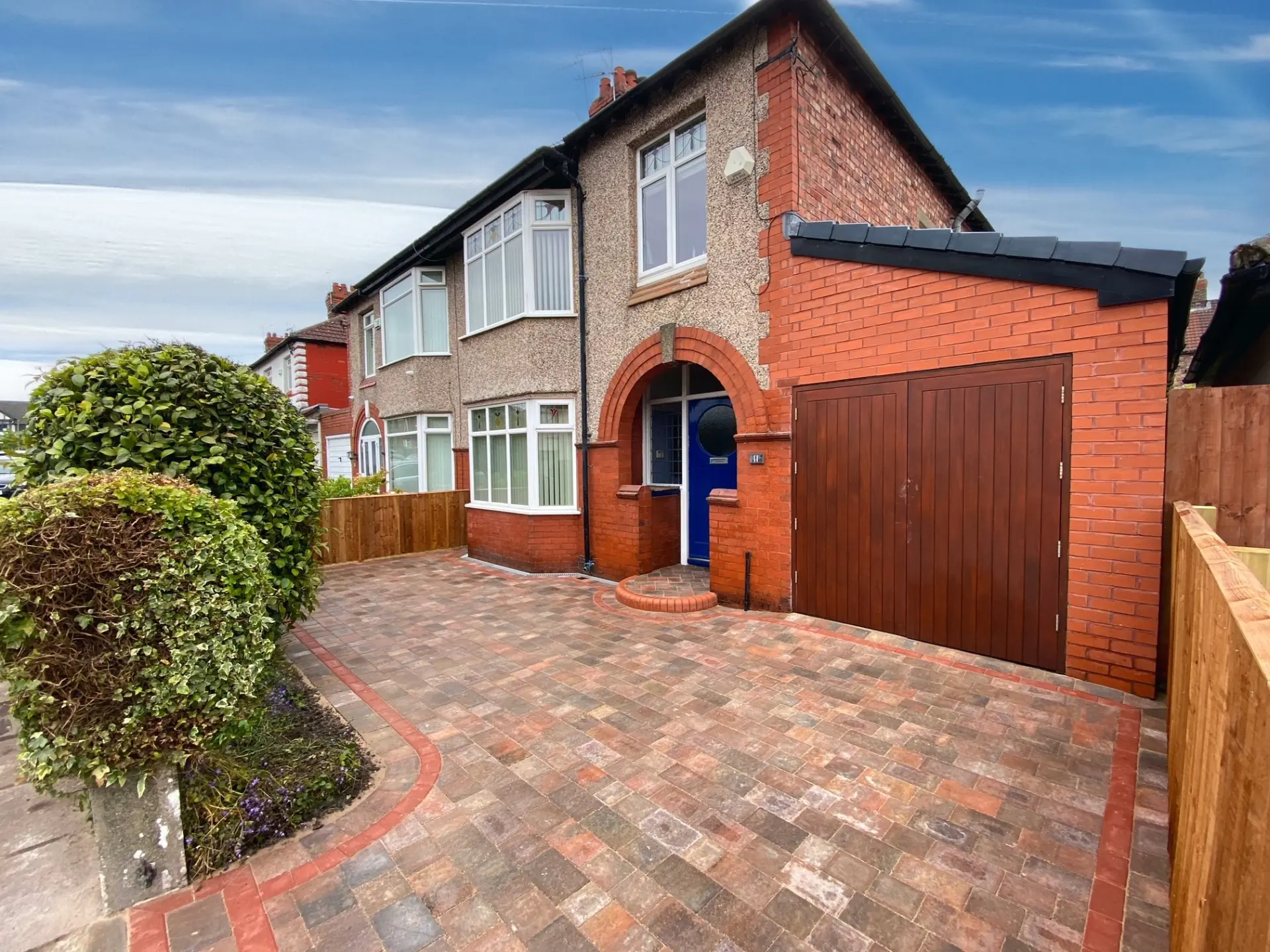 Multi-tone block paved driveway with red brick borders