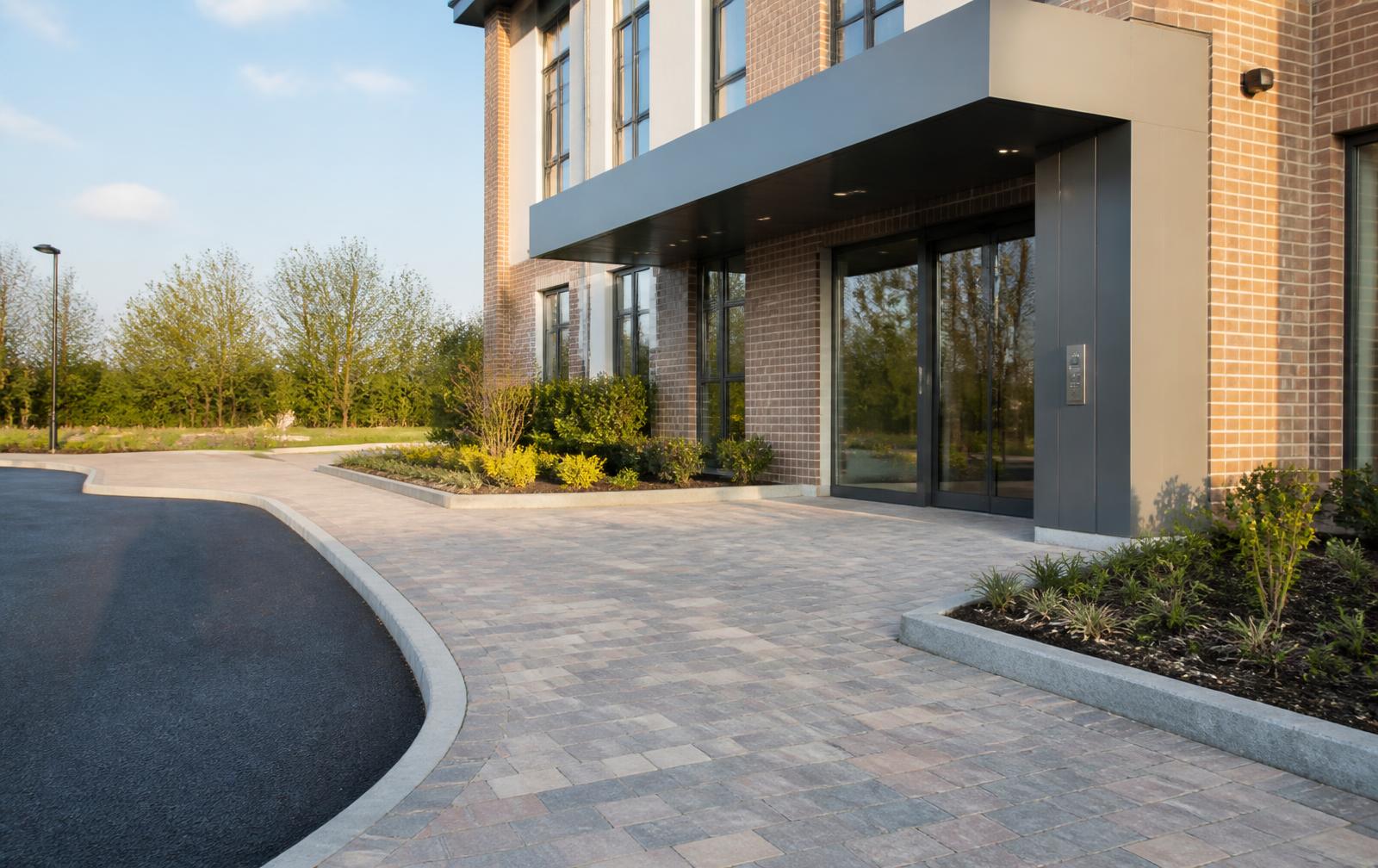 A commercial building entrance with paved approach